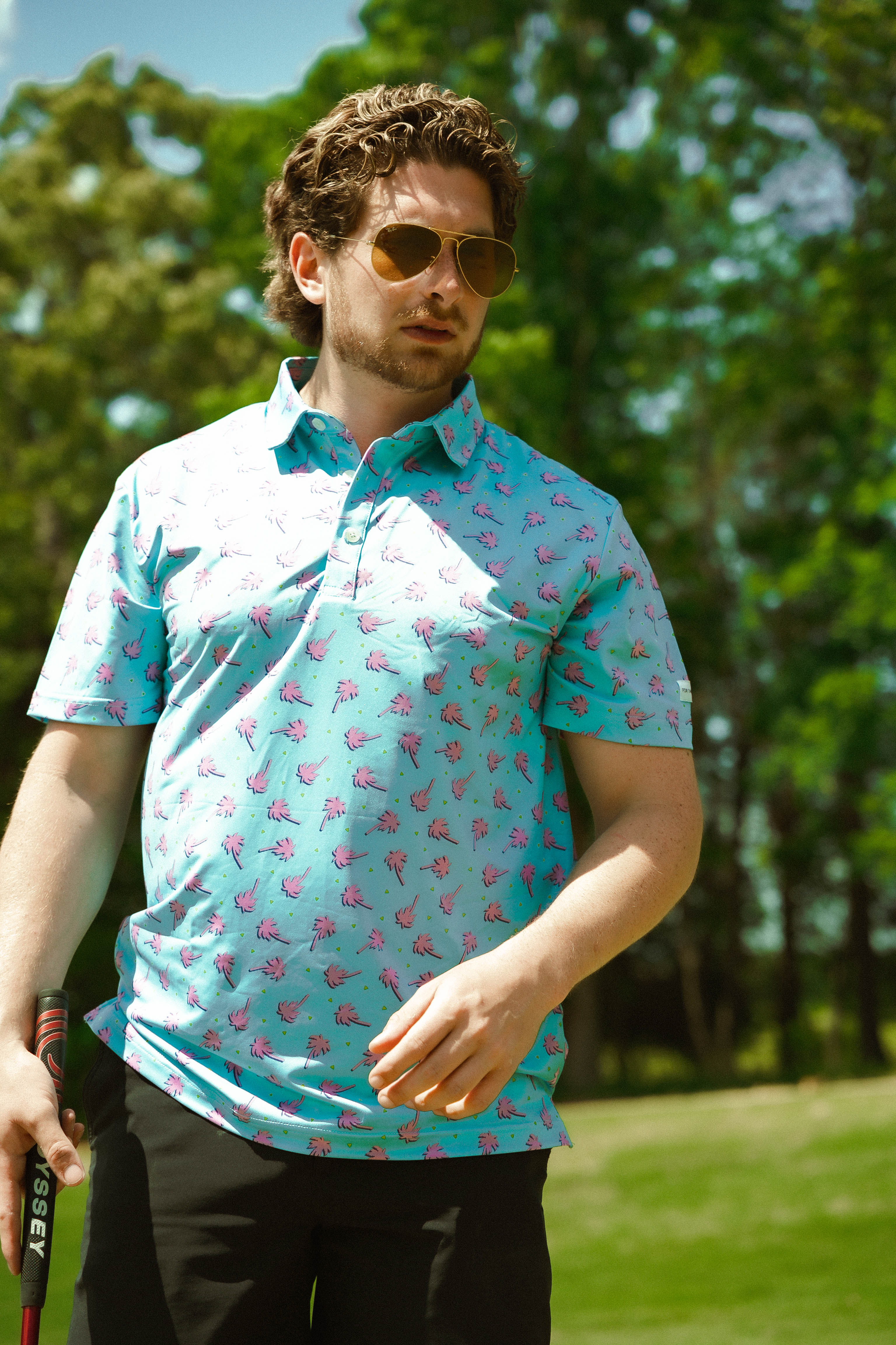 For the birds golf mens patterned golf polo with tropical palm tree patters.