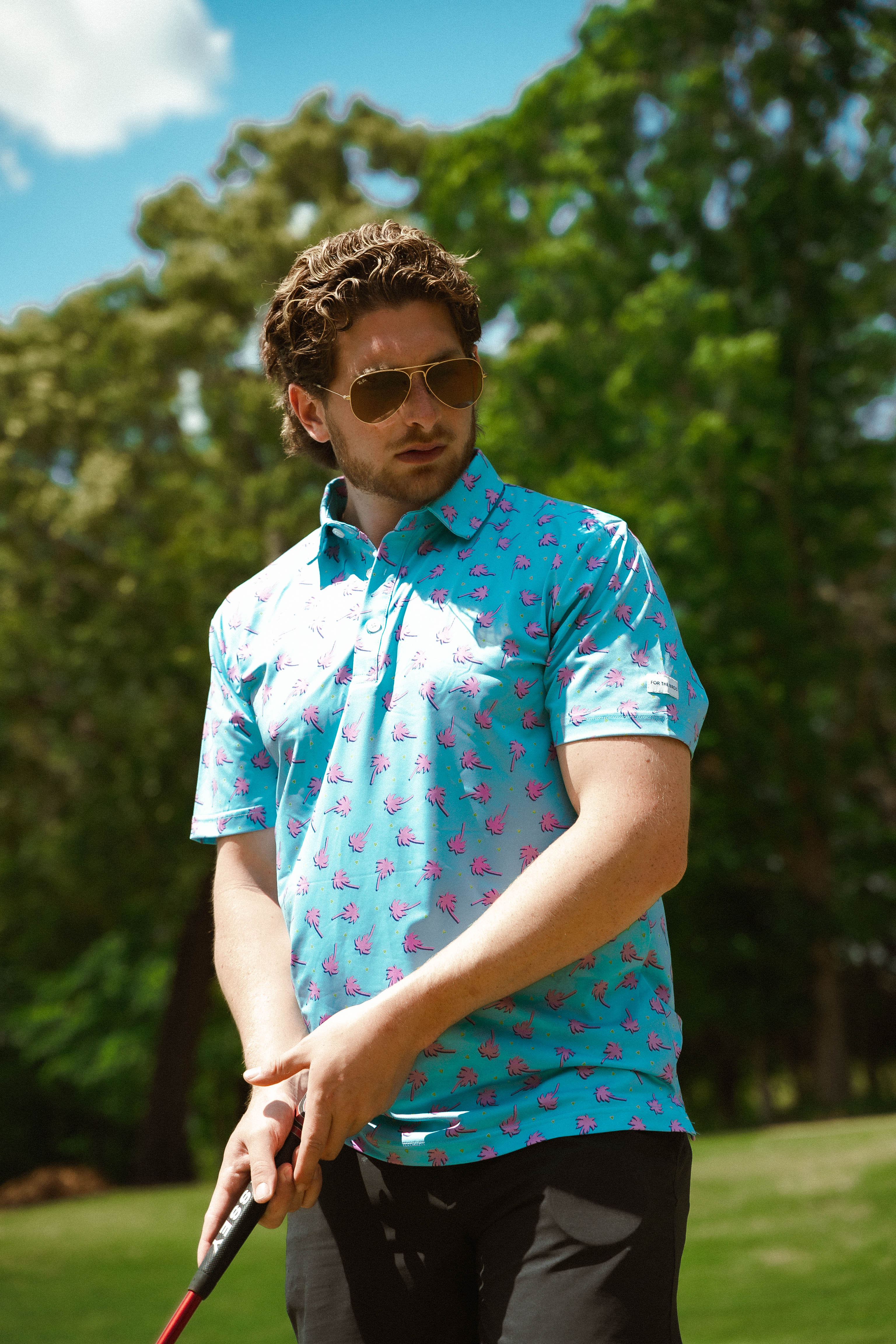 For the birds golf mens patterned golf polo with tropical palm tree patters.