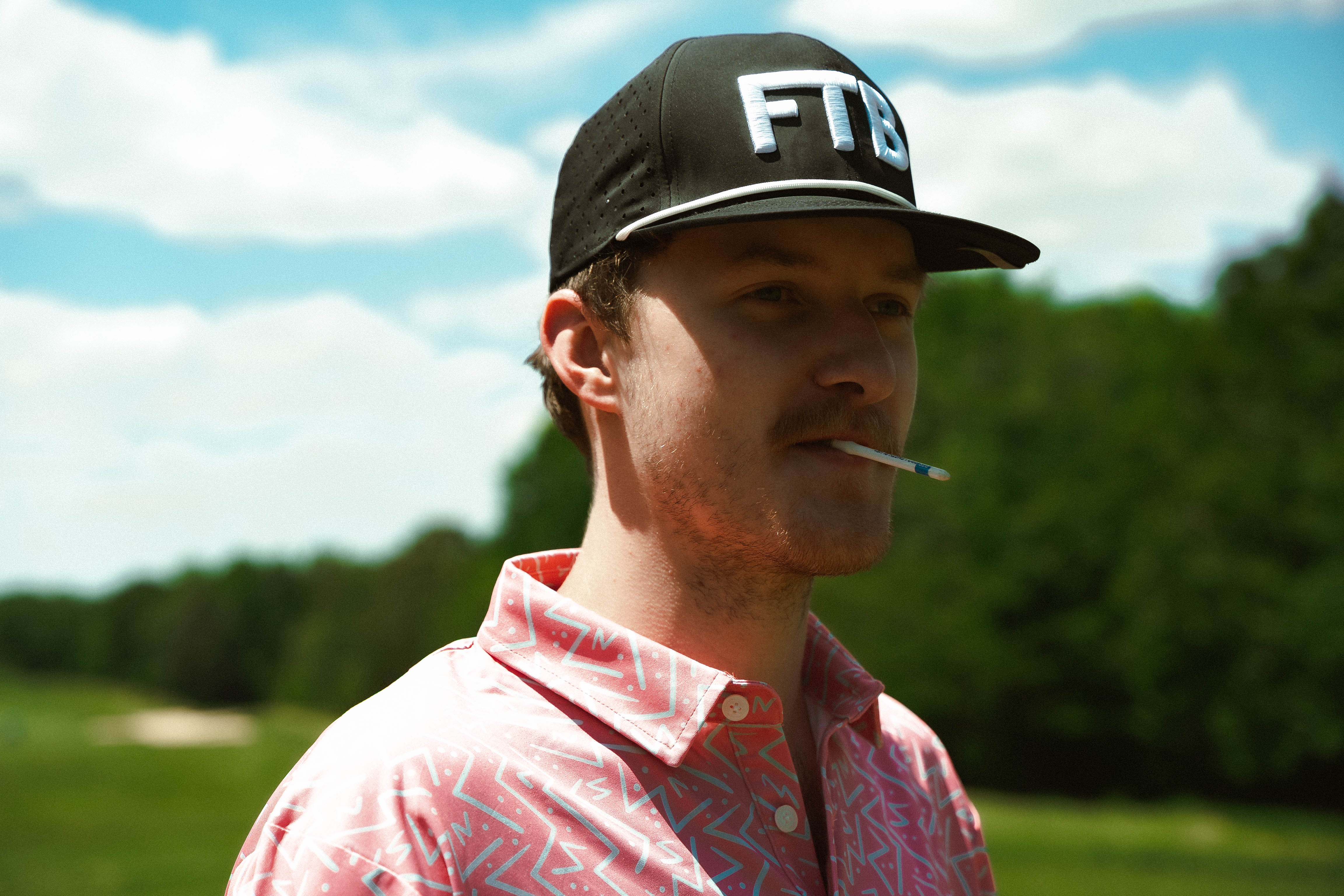 Awesome bright men’s golf polo by for the birds golf co with throwback zig zag pattern